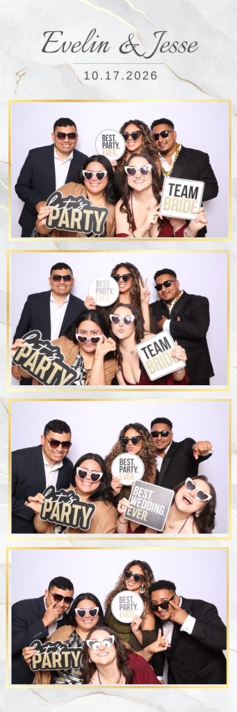 Friends posing at a wedding photo booth